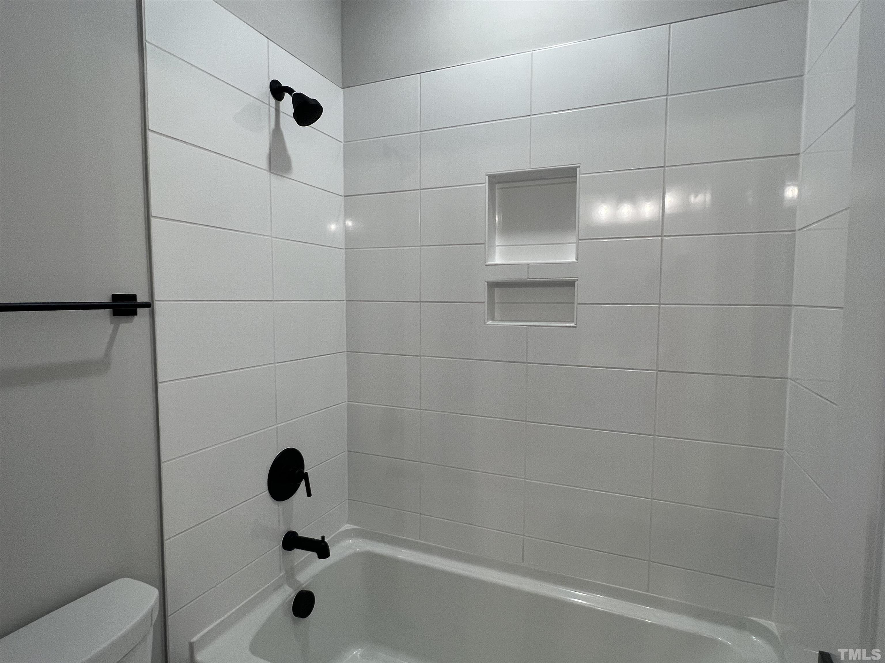 7629 Hasentree Way, Unit 519 Wake Forest, NC 27587 - Photo 43 of 76 a bathroom with a bathtub and shower