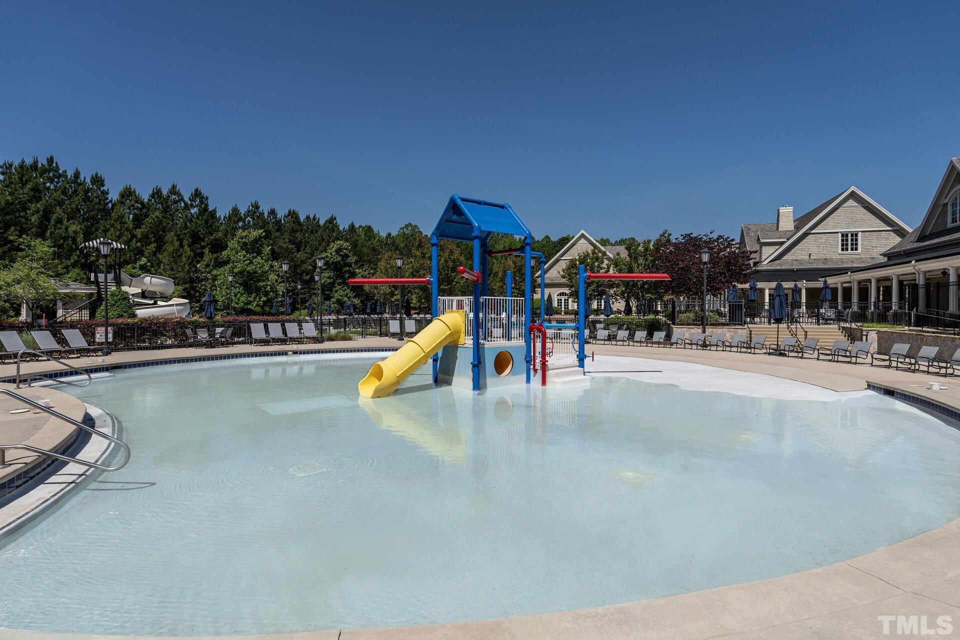 7629 Hasentree Way, Unit 519 Wake Forest, NC 27587 - Photo 64 of 76 a view of a swimming pool with a bench and lawn chairs