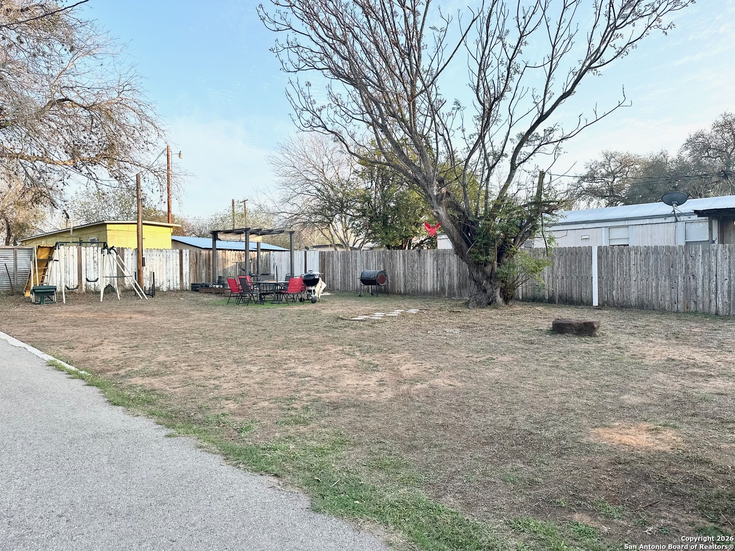 1608 The Ln Street Pleasanton, TX 78064 - Photo 3 of 10 a view of a house with a large tree in front of it