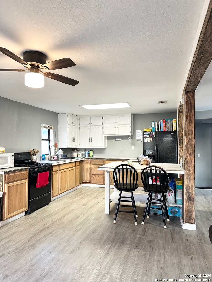 1608 The Ln Street Pleasanton, TX 78064 - Photo 5 of 10 a kitchen with a dining table chairs and kitchen view