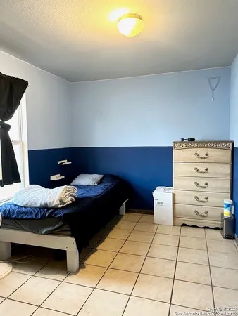 a bedroom with furniture and a window