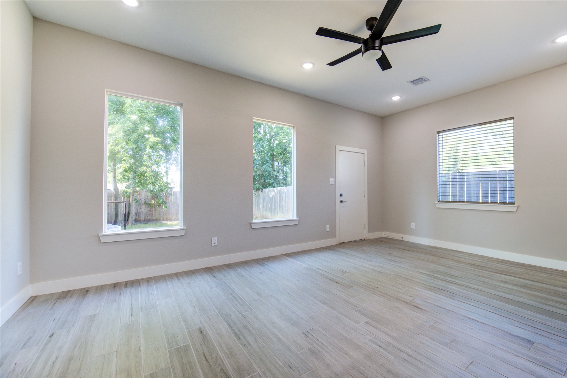 4536 Sunflower Street Houston, TX 77051 - Photo 11 of 27 a view of an empty room with wooden floor and a window