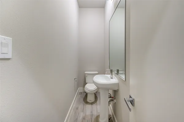 a bathroom with a white toilet and a sink