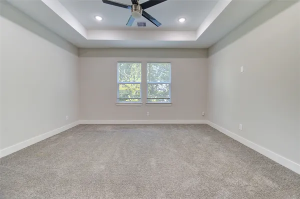 an empty room with a window and a projector screen
