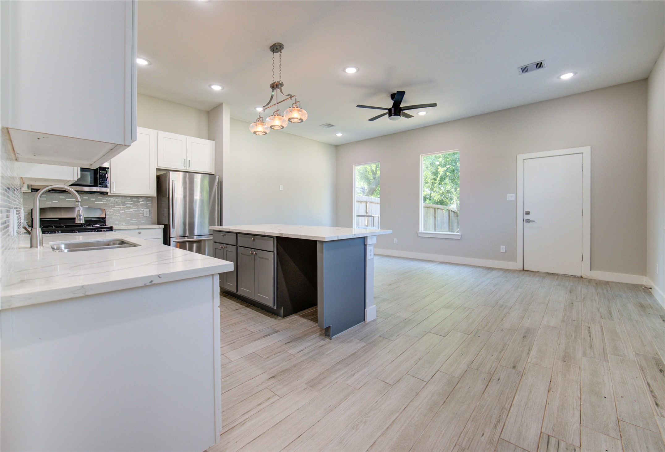 4536 Sunflower Street Houston, TX 77051 - Photo 3 of 27 a kitchen with kitchen island a sink stainless steel appliances and window