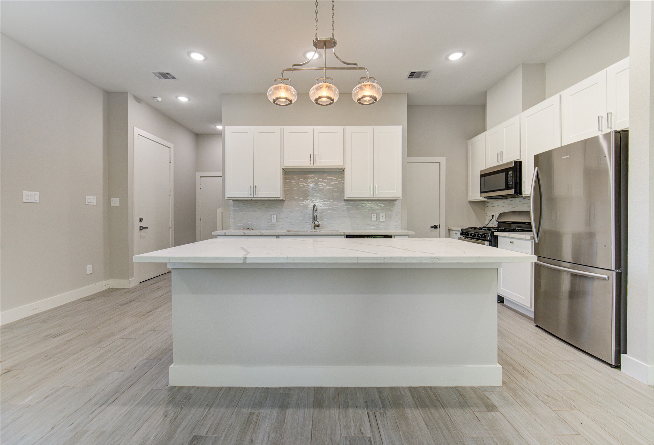 4536 Sunflower Street Houston, TX 77051 - Photo 4 of 27 a kitchen with stainless steel appliances a refrigerator sink and microwave