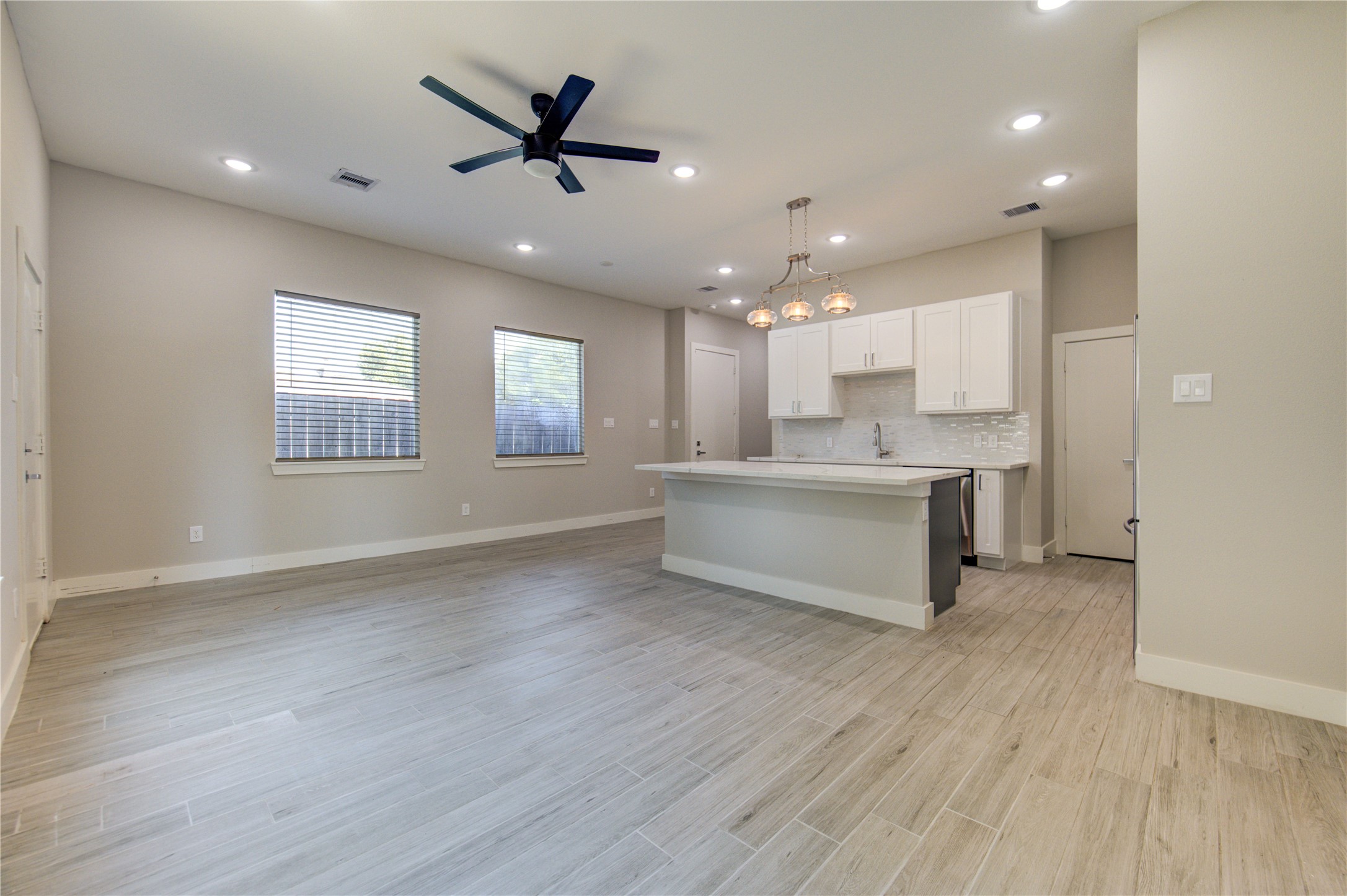 4536 Sunflower Street Houston, TX 77051 - Photo 5 of 27 a view of an empty room with kitchen appliances and a ceiling fan