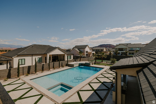 2281 South Crimson Cliffs Way St. George, UT 84790 - Photo 33 of 47 Relaxing pool / spa with a residential view, a patio, and a fenced backyard