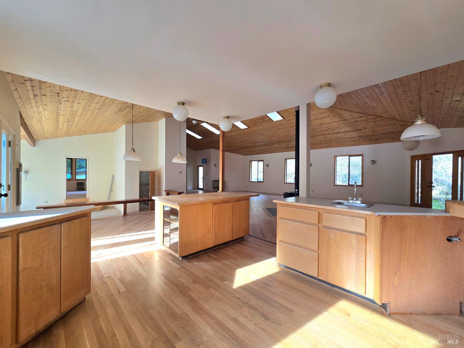 36955 Eureka Stagecoach Road Willits, CA 95490 - Photo 15 of 45 a large kitchen with stainless steel appliances kitchen island a large counter top and a wooden floors