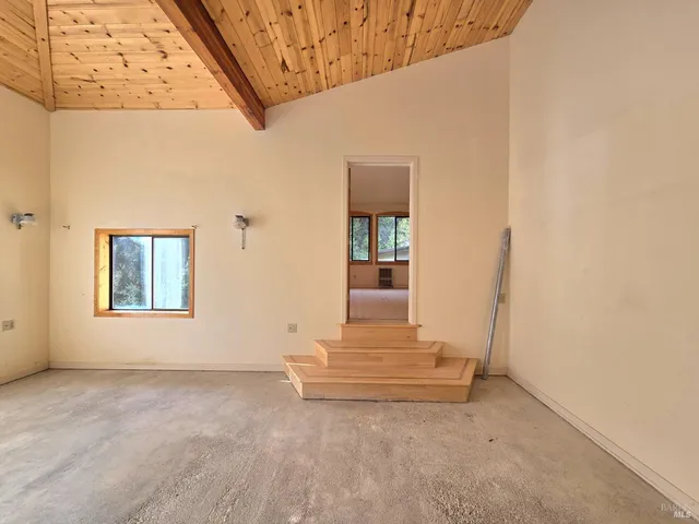 a view of wooden floor and a refrigerator in a room