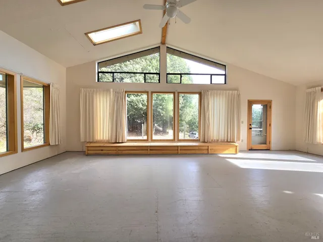 an empty room with large windows and view