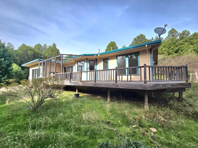 a view of a house with backyard and sitting area