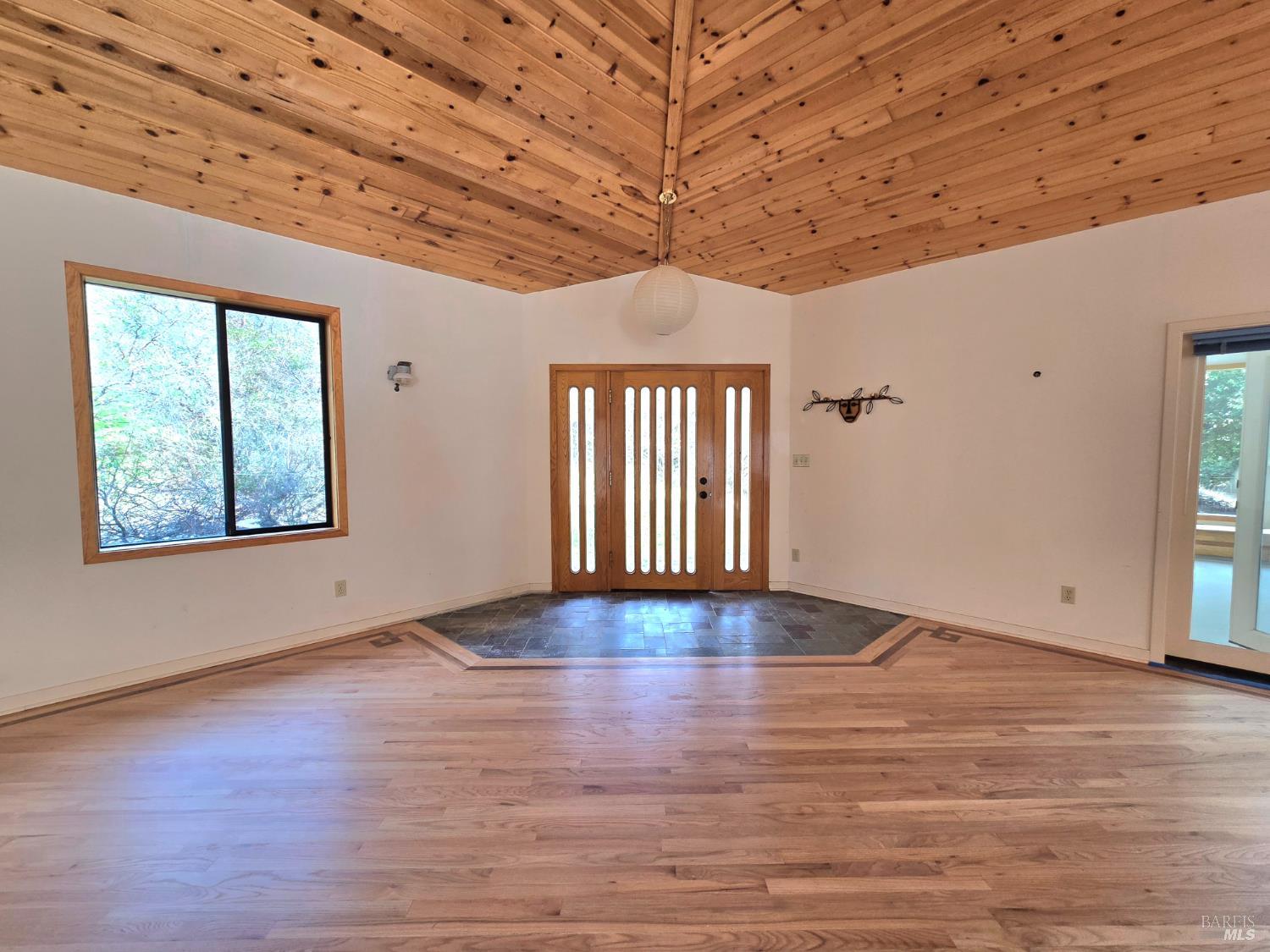 36955 Eureka Stagecoach Road Willits, CA 95490 - Photo 6 of 45 an empty room with wooden floor and windows