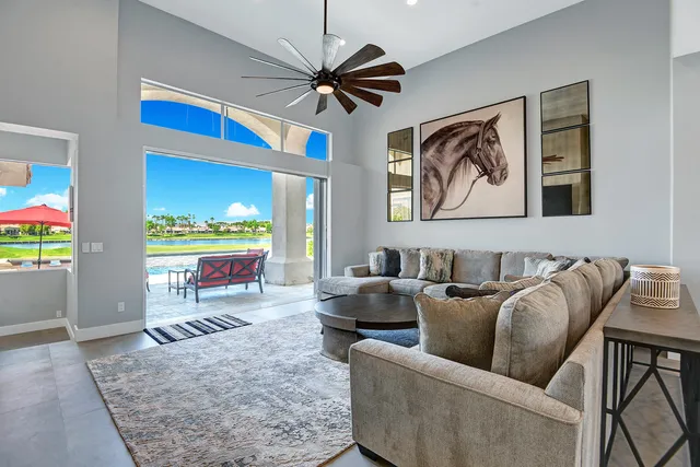 a living room with furniture a window and a flat screen tv