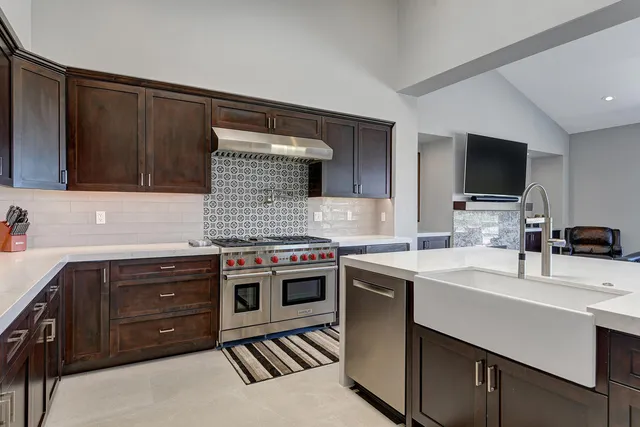 a kitchen with a sink stove and microwave