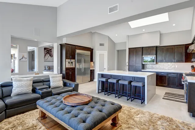 a living room with furniture and a kitchen