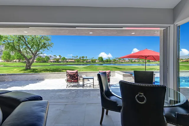 a table and chairs sitting in front of a house