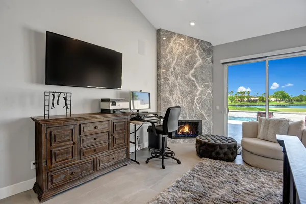 a large bedroom with a bed and a chandelier