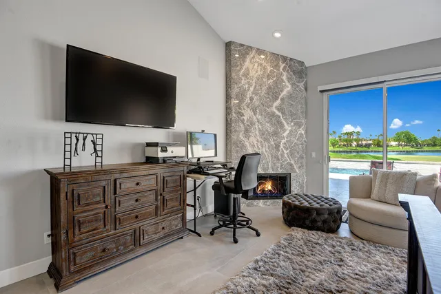 a large bedroom with a bed and a chandelier