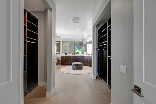 a spacious bathroom with a tub a double vanity and window