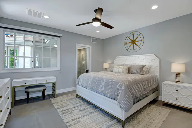 a bedroom with a large bed and a flat tv screen on dresser