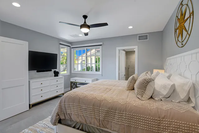 a bathroom with a granite countertop sink a toilet and shower