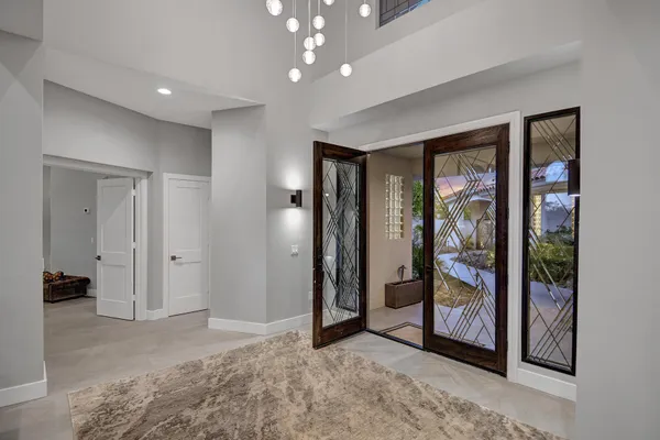 a view of an empty room with glass door and glass door
