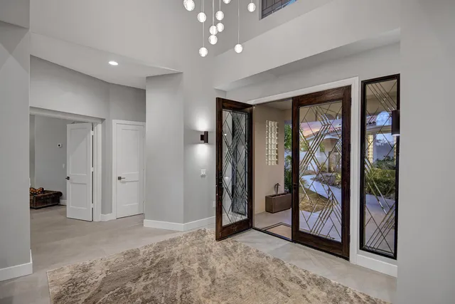 a view of an empty room with glass door and glass door