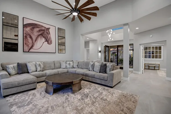 a living room with furniture and a chandelier