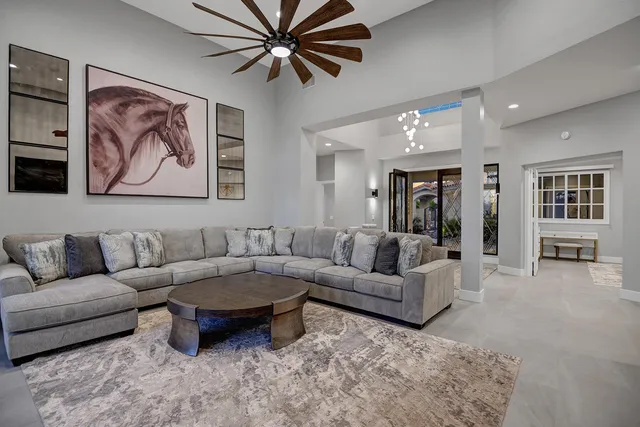 a living room with furniture and a chandelier