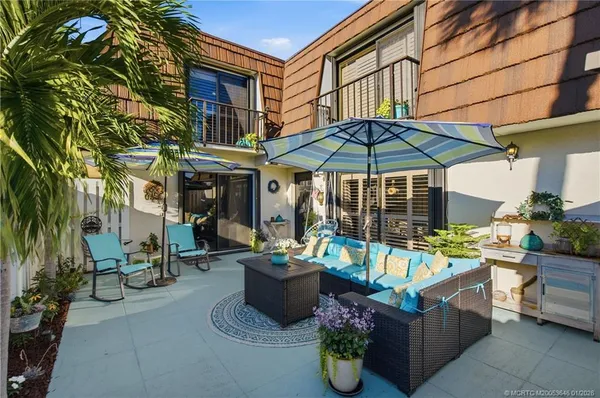 a view of a chairs and table in the patio
