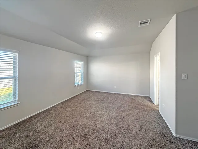 a bathroom with a tub sink shower and mirror