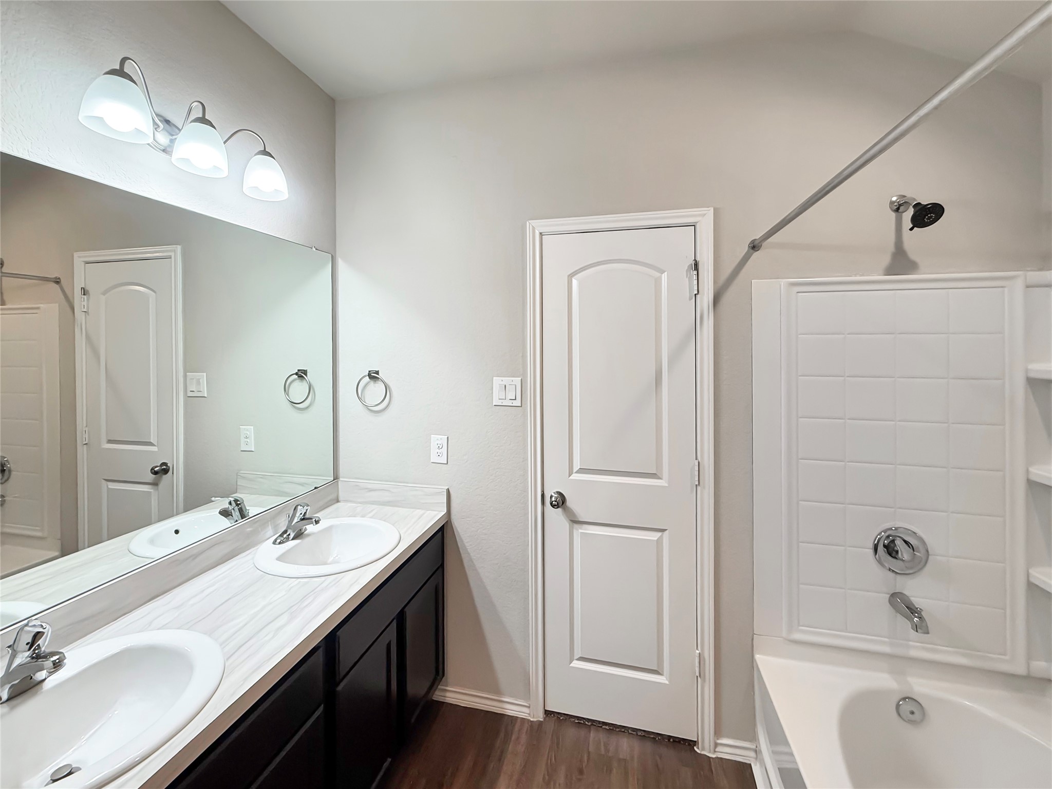 15443 Cipres Verde Street Channelview, TX 77530 - Photo 15 of 27 a bathroom with a double vanity sink a mirror and a bathtub