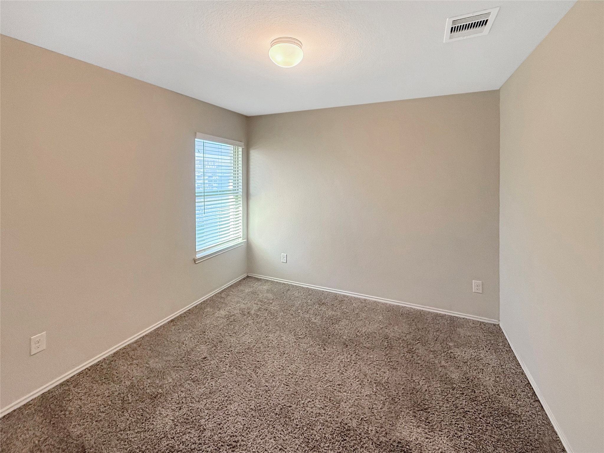 15443 Cipres Verde Street Channelview, TX 77530 - Photo 19 of 27 an empty room with windows