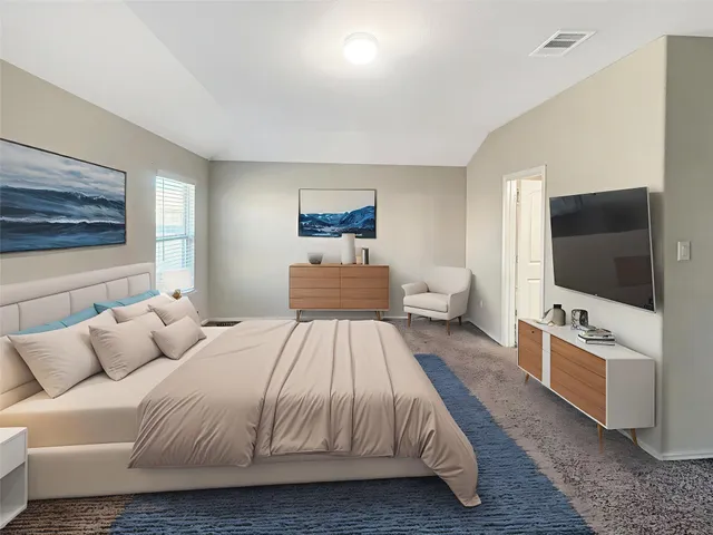a bedroom with a bed and a flat screen tv