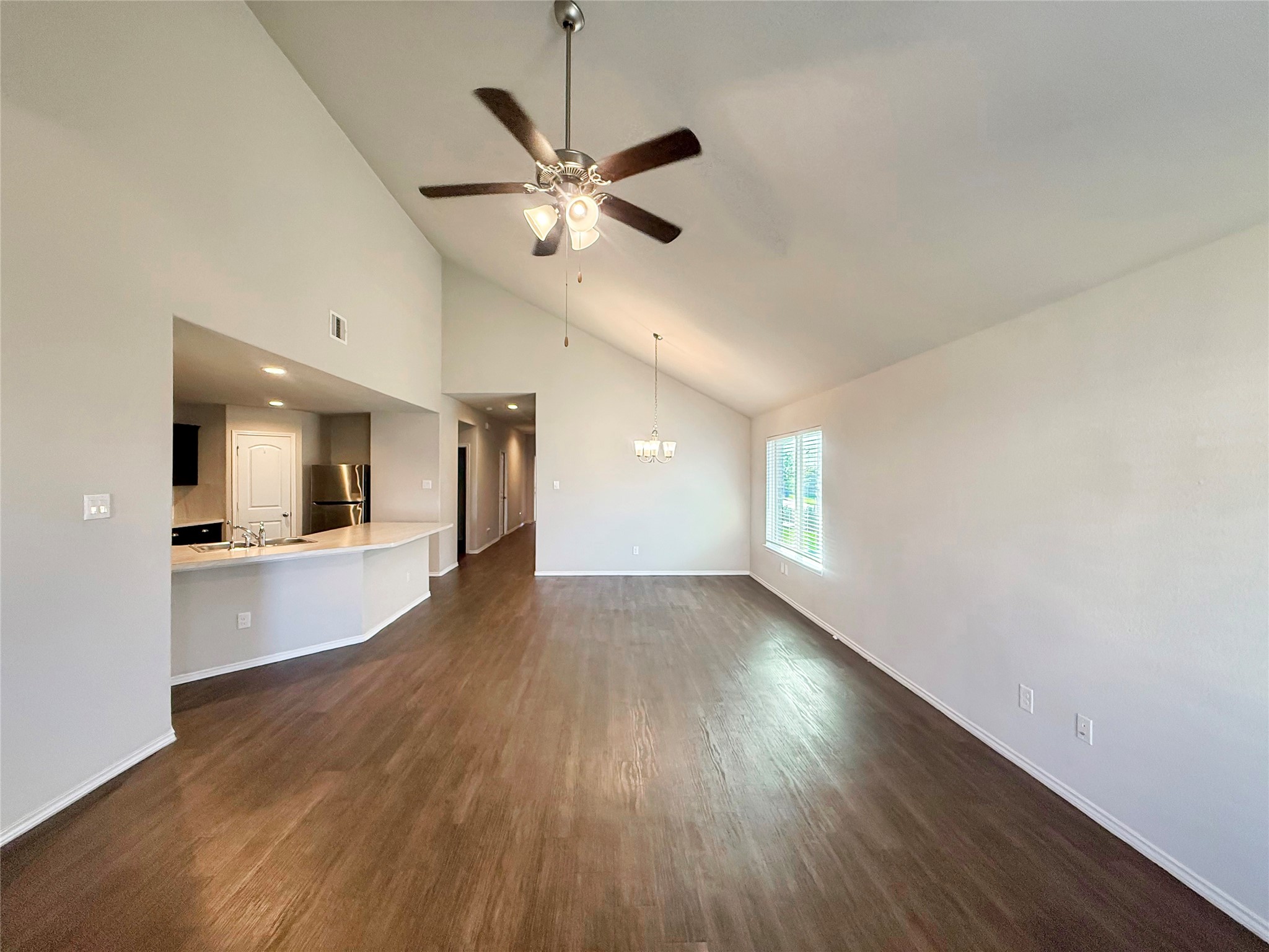 15443 Cipres Verde Street Channelview, TX 77530 - Photo 5 of 27 a view of an empty room with wooden floor and a window