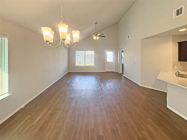 a view of a room with wooden floor and bathroom