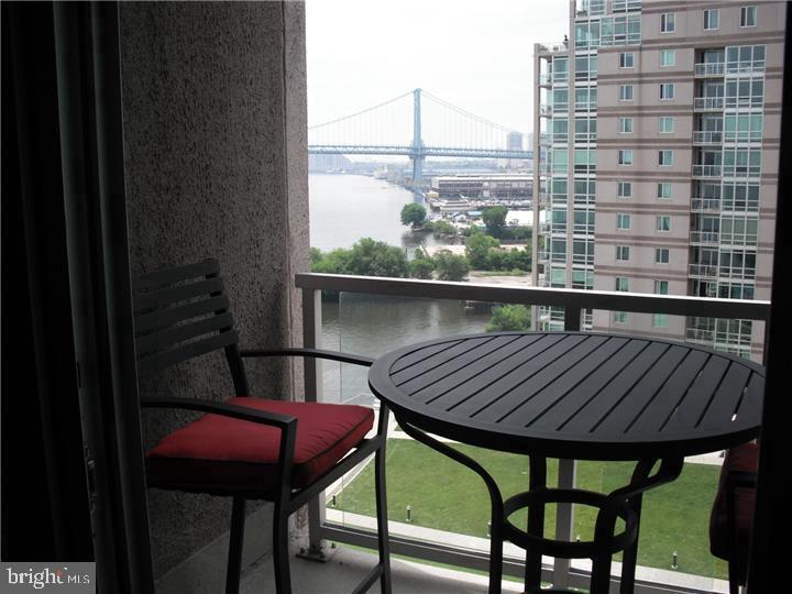 901 North Penn Street, Unit R903 Philadelphia, PA 19123 - Photo 12 of 18 a view of balcony with wooden floor and outdoor seating