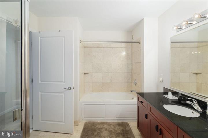901 North Penn Street, Unit R903 Philadelphia, PA 19123 - Photo 9 of 18 a bathroom with a granite countertop sink toilet and shower