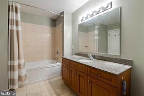 901 North Penn Street, Unit R903 Philadelphia, PA 19123 - Photo 10 of 18 a bathroom with a granite countertop sink mirror and a bathtub