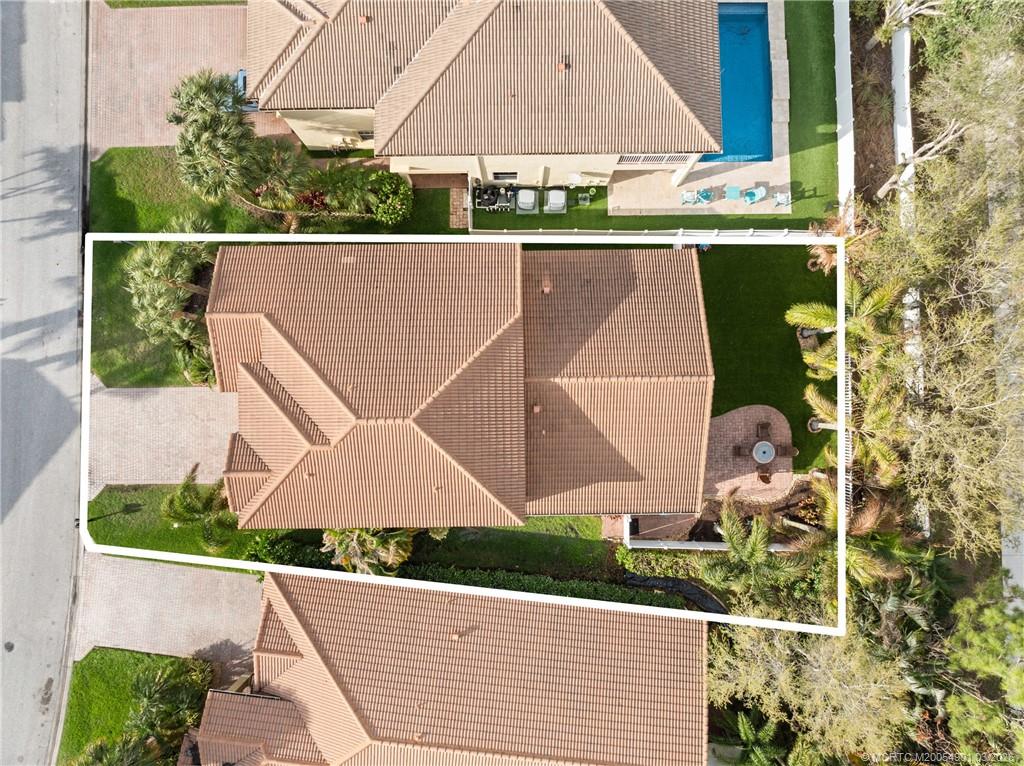 2973 Southwest Porpoise Circle Stuart, FL 34997 - Photo 11 of 47 an aerial view of a house with a yard and a garage