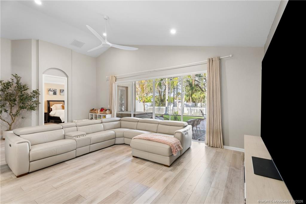 2973 Southwest Porpoise Circle Stuart, FL 34997 - Photo 12 of 47 a living room with furniture and a large window