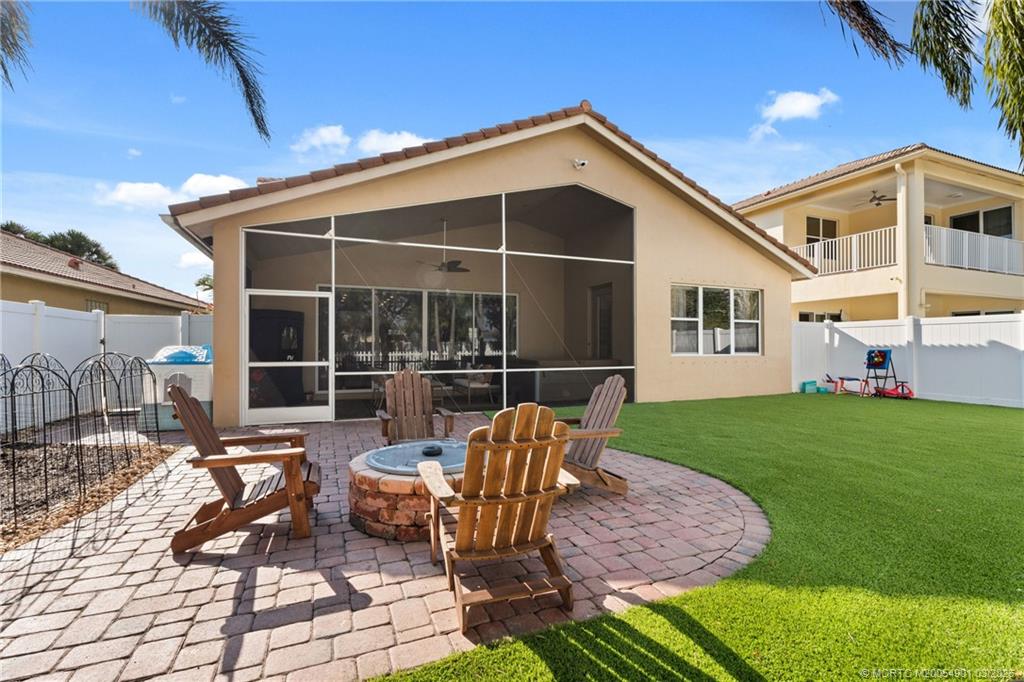 2973 Southwest Porpoise Circle Stuart, FL 34997 - Photo 13 of 47 a view of a house with backyard sitting area and garden