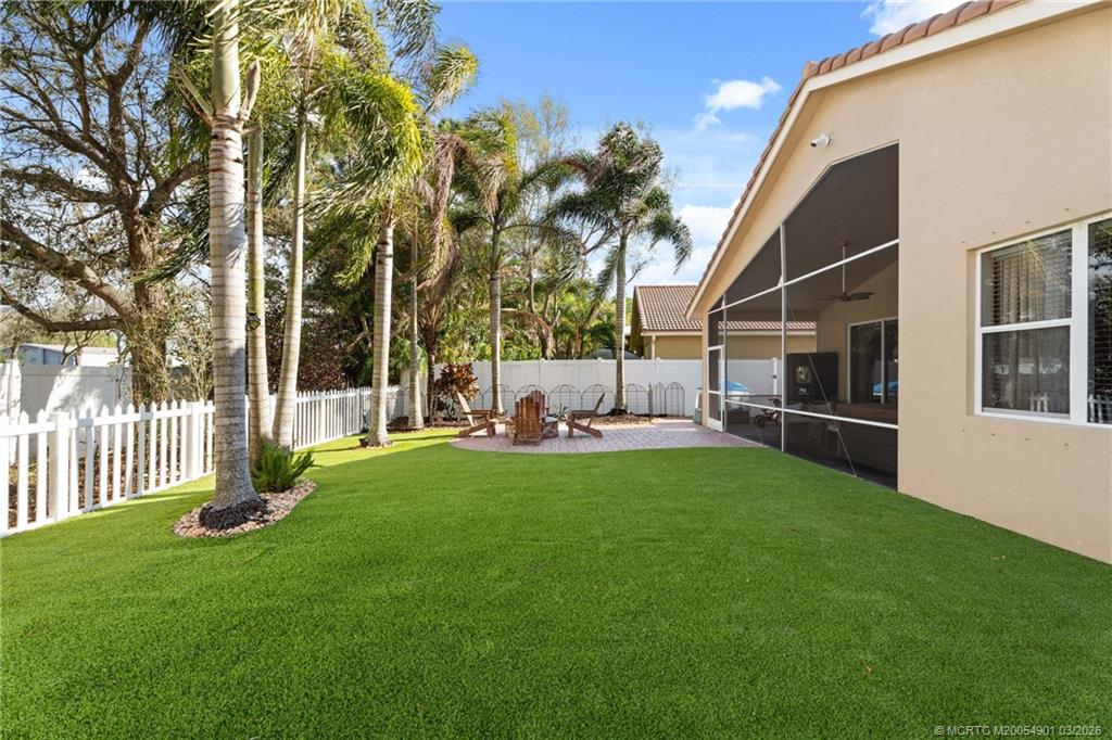 2973 Southwest Porpoise Circle Stuart, FL 34997 - Photo 15 of 47 a view of backyard with a garden and slide