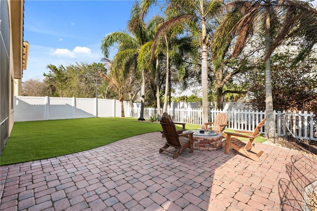 2973 Southwest Porpoise Circle Stuart, FL 34997 - Photo 16 of 47 a garden view with a seating space