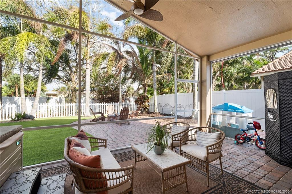 2973 Southwest Porpoise Circle Stuart, FL 34997 - Photo 18 of 47 a patio with yard table and chairs