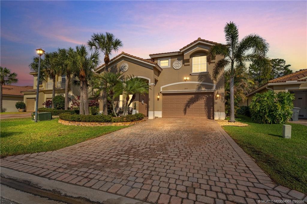 2973 Southwest Porpoise Circle Stuart, FL 34997 - Photo 2 of 47 a front view of a house with a yard