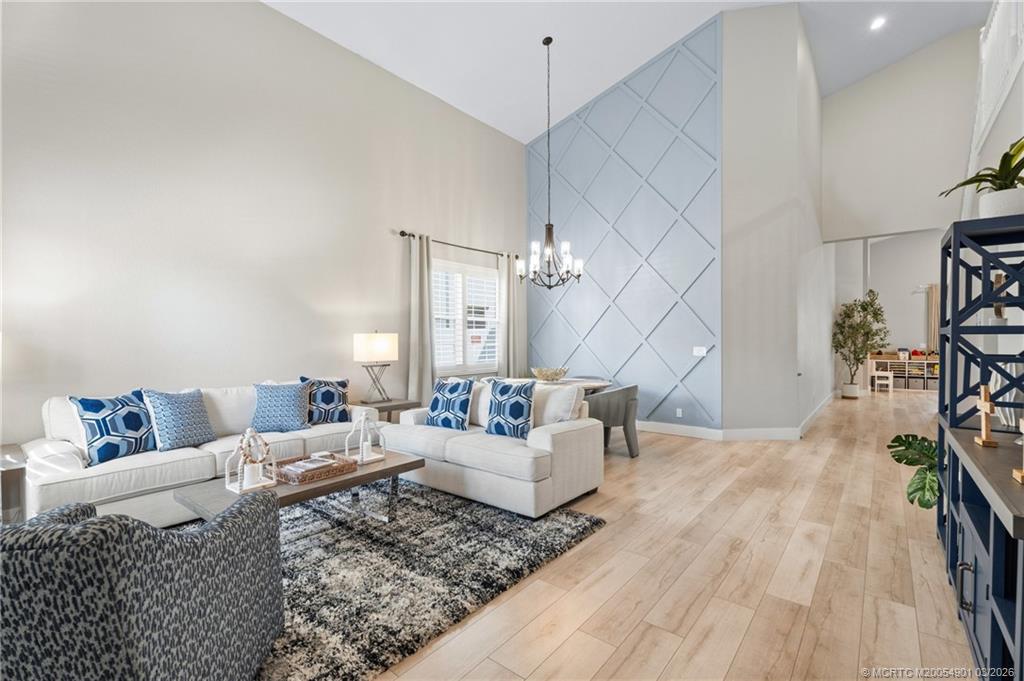 2973 Southwest Porpoise Circle Stuart, FL 34997 - Photo 3 of 47 a living room with furniture and wooden floor