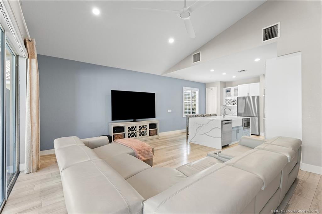 2973 Southwest Porpoise Circle Stuart, FL 34997 - Photo 33 of 47 a living room with furniture and a flat screen tv