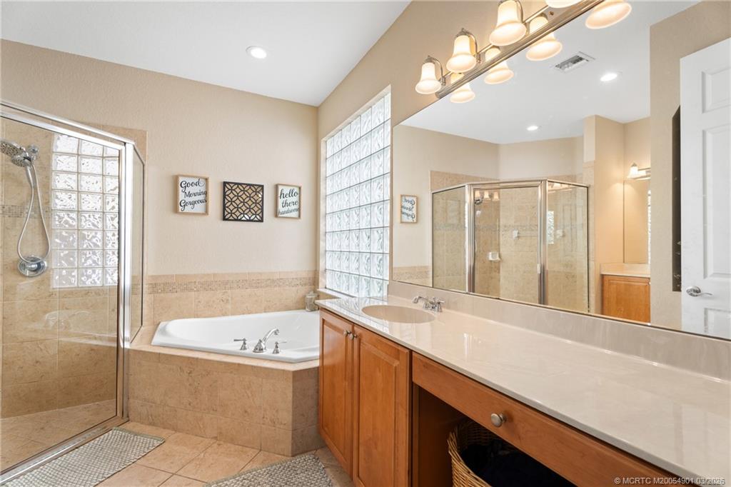 2973 Southwest Porpoise Circle Stuart, FL 34997 - Photo 35 of 47 a bathroom with a bathtub and a sink